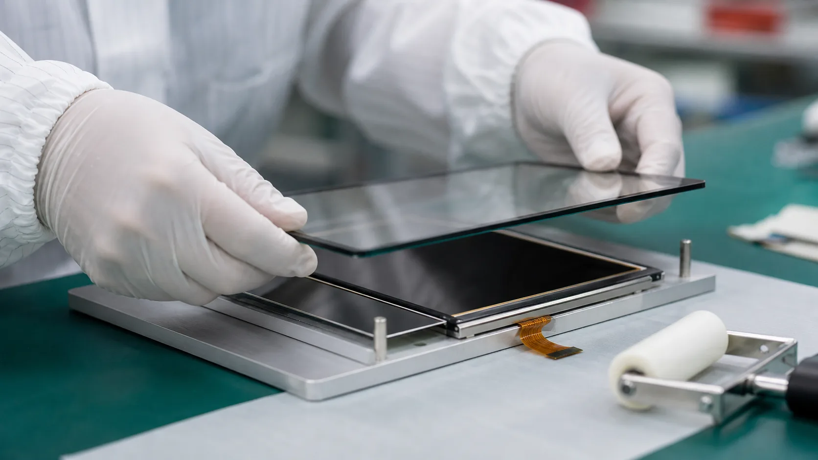 Cover glass aligned over a TFT display module during OCA bonding